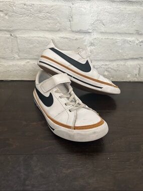 Nike White Low-Top Sneakers with Black Swoosh and Brown Trim